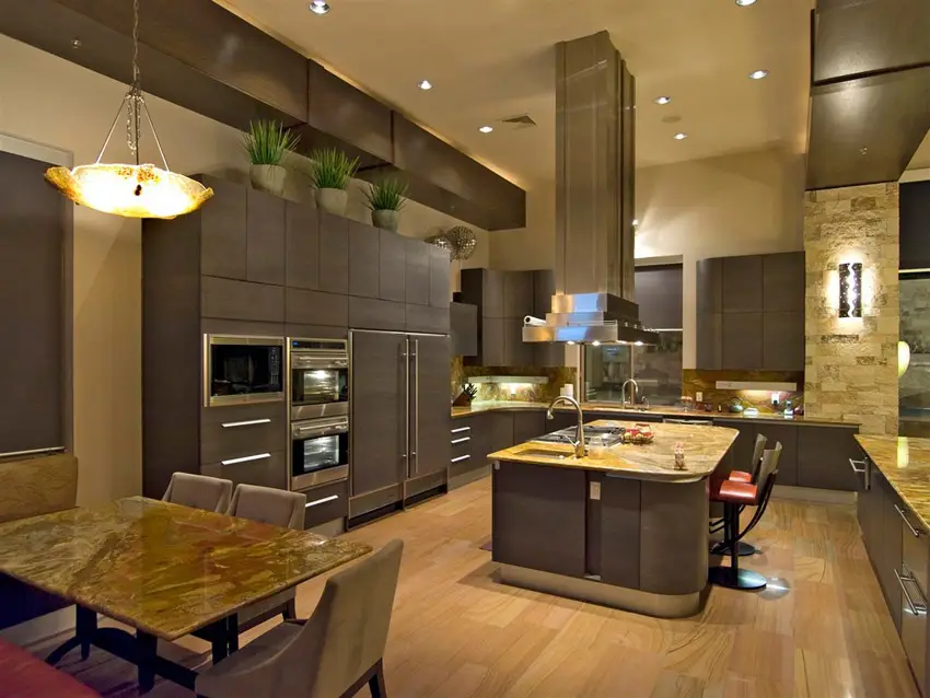 Contemporary kitchen with high ceilings, light wood floors and dark cabinets