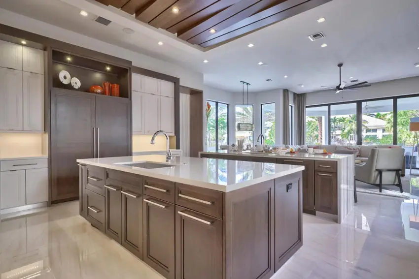 Contemporary kitchen with limestone and rich wood cabinetry