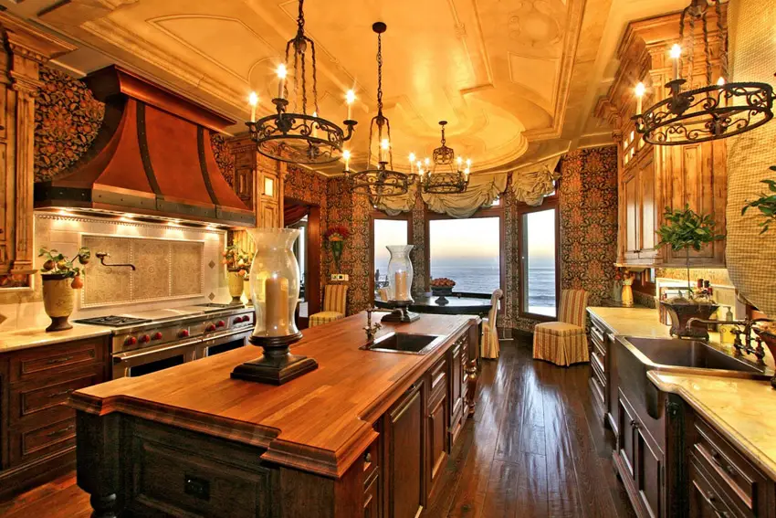 Kitchen with dark green brocade wallpaper, carved ceiling and iron chandeliers