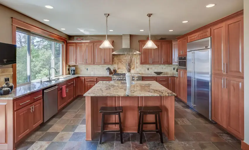 Kitchen with beige granite counter raised stone tile floor