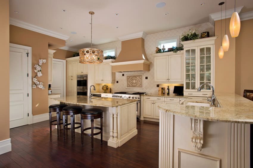 Kitchen with white cabinets, island and mahogany floors