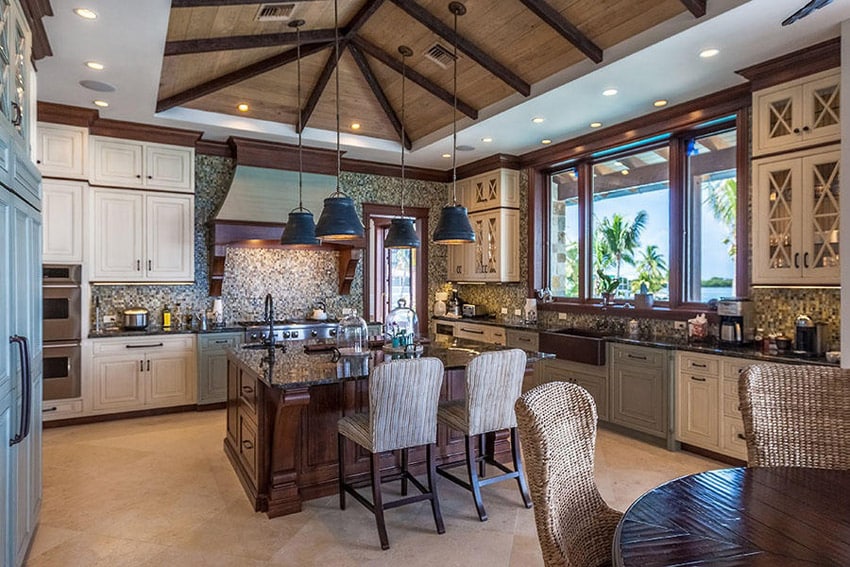Luxury kitchen with limestone tile flooring vaulted ceilings