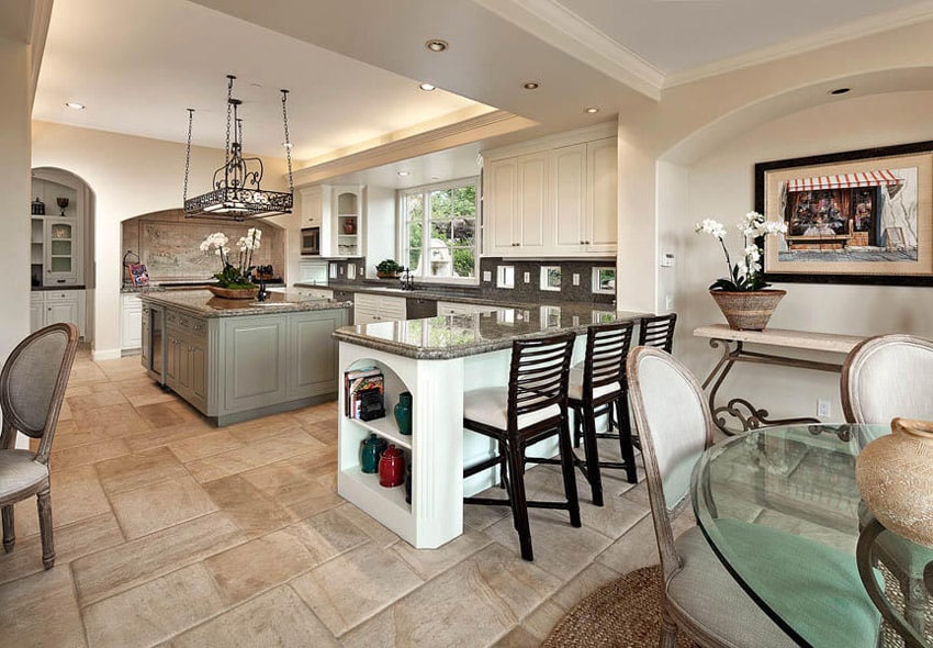 Kitchen with partial open plan design and white cabinets with an sage green island