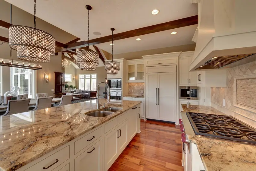 Kitchen with drum chandeliers, backsplash with inlay and grey chairs