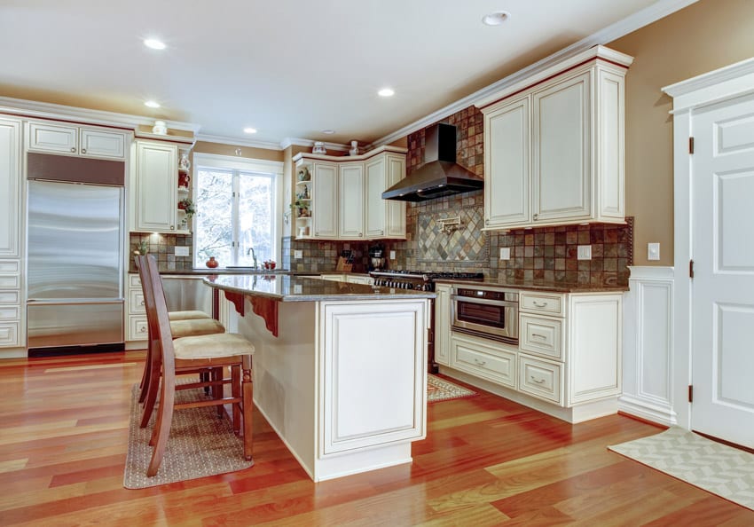 Kitchen with white cabinets and cherry flooring
