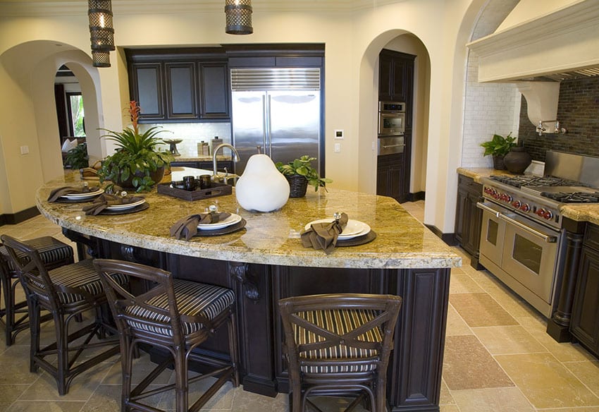 Kitchen with yellow granite counters and curved eat in island