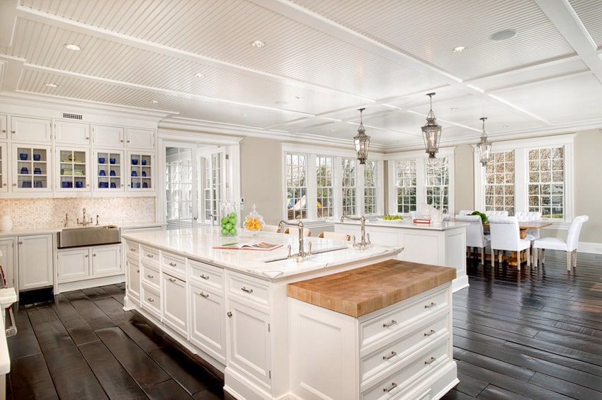 Kitchen with french windows, dark wood floors and white cabinets