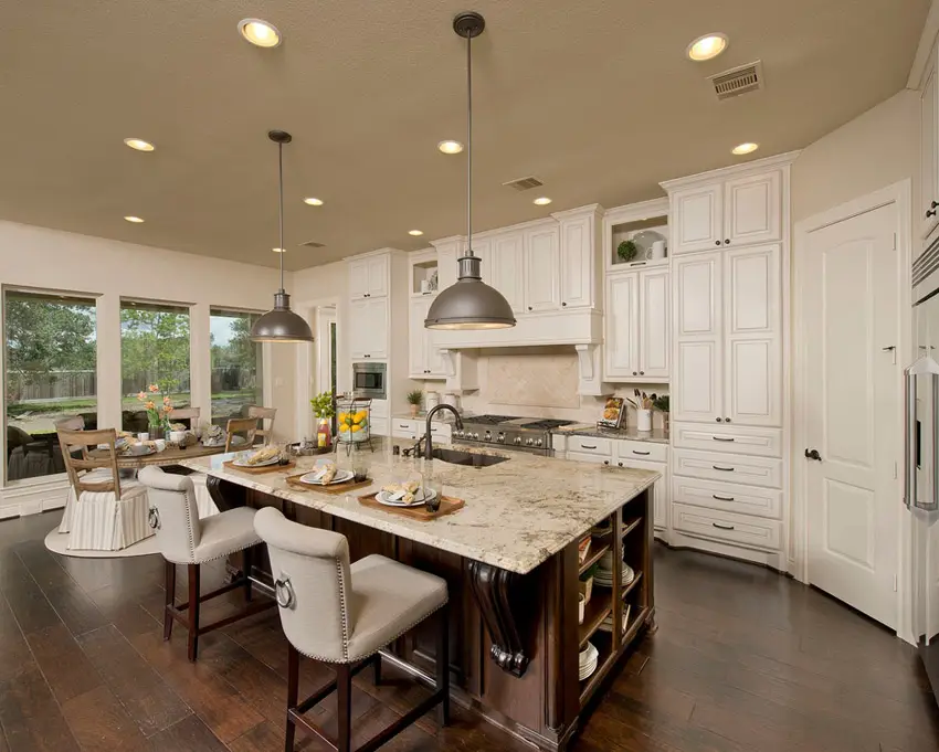 Kitchen with modular cabinets, beige fabric chairs and dome lights