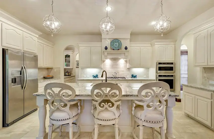 Paneled kitchen cabinet doors, Alpine white counters and modern pendant lights