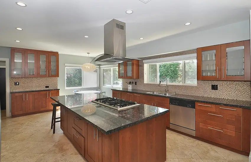 Rich wood cabinet kitchen with mosaic tile back splash