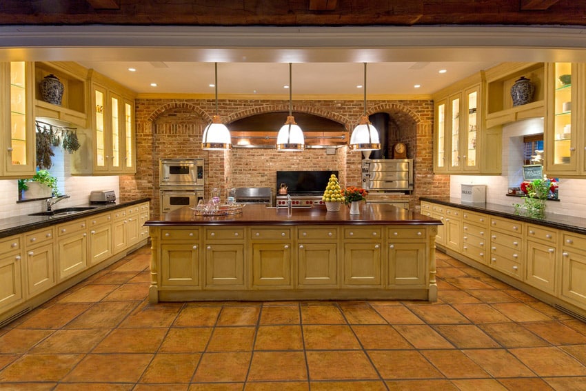 Spacious kitchen with maple cabinets and porcelain floor tile