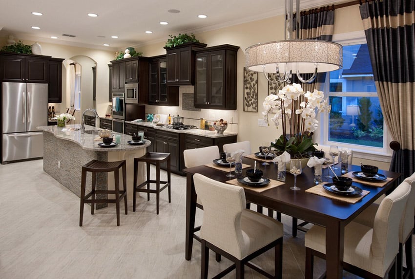 Transitional style design with dark cabinetry and white drum chandelier