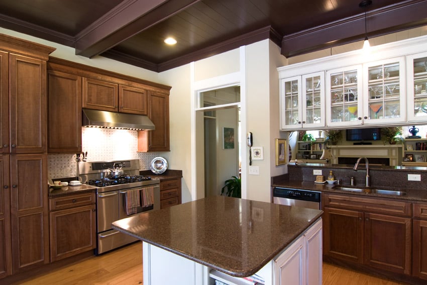 Kitchen with walnut cabinets and small island with white base