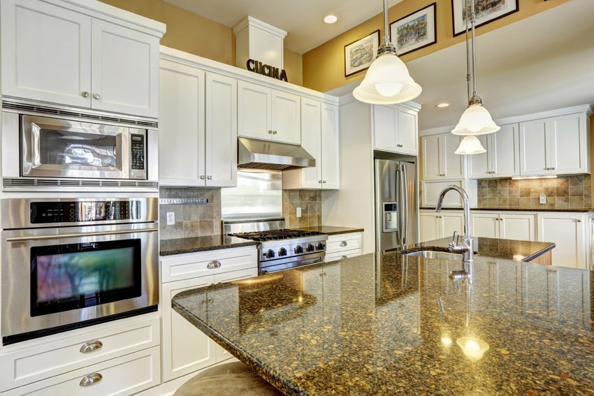 White kitchen cabinets with yellow granite counters