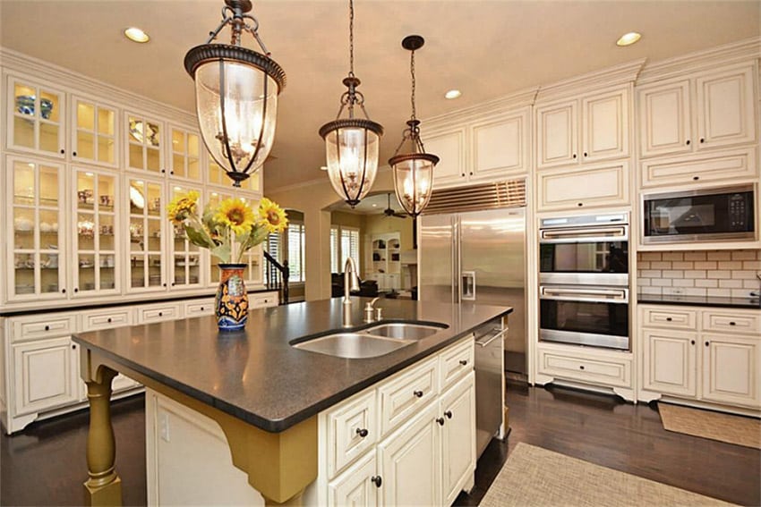 White kitchen with dark concrete countertops and white cabinetry