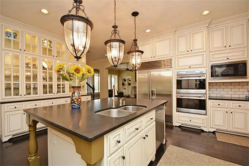 Transirtional kitchen with dark concrete counters and white cabinetry