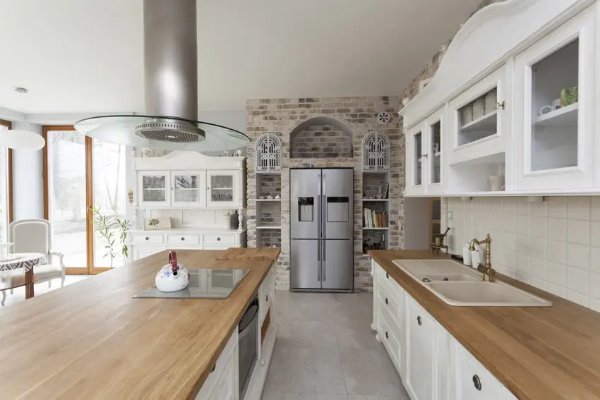 Kitchen with wood counters and brick accent wall