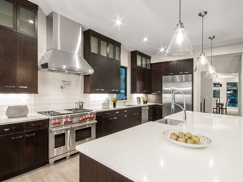 kitchen with European style cabinets with dark wood finish and white quartz slabs