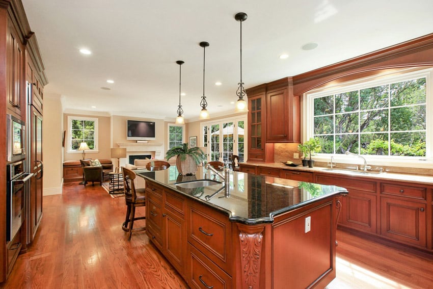 Wood kitchen with emerald pearl counters and teak engineered wood floors