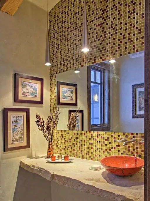 Bathroom with square mosaic tile and brushed metal pendant lights