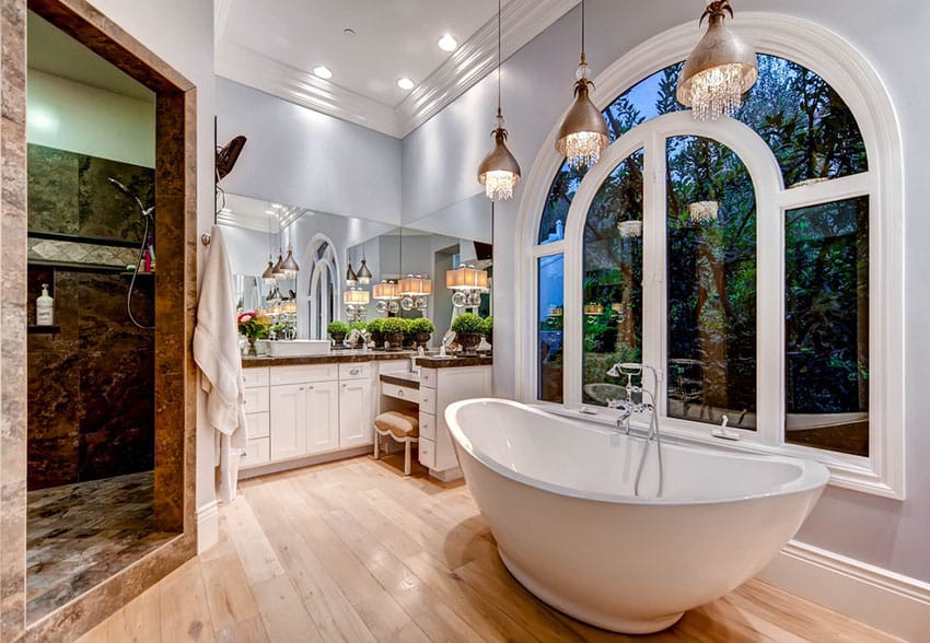 Beautiful bathroom with center tub and elegant pendants with hanging glass