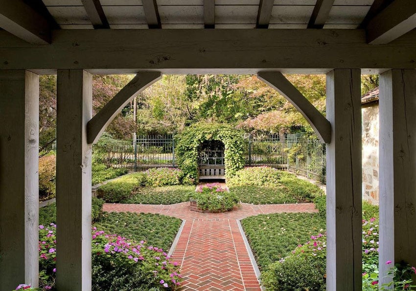 Brick walkway with chevron pattern through garden