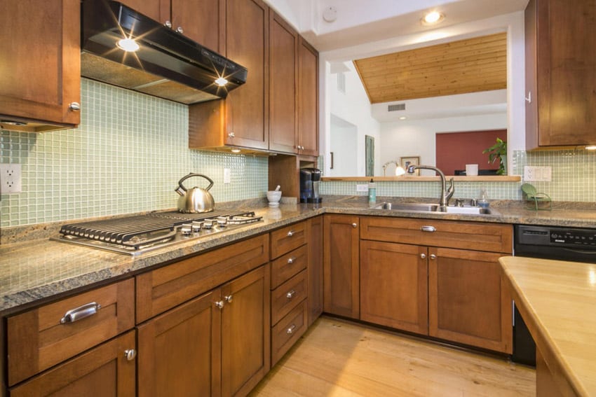 Compact kitchen with pecan color hardwood flooring