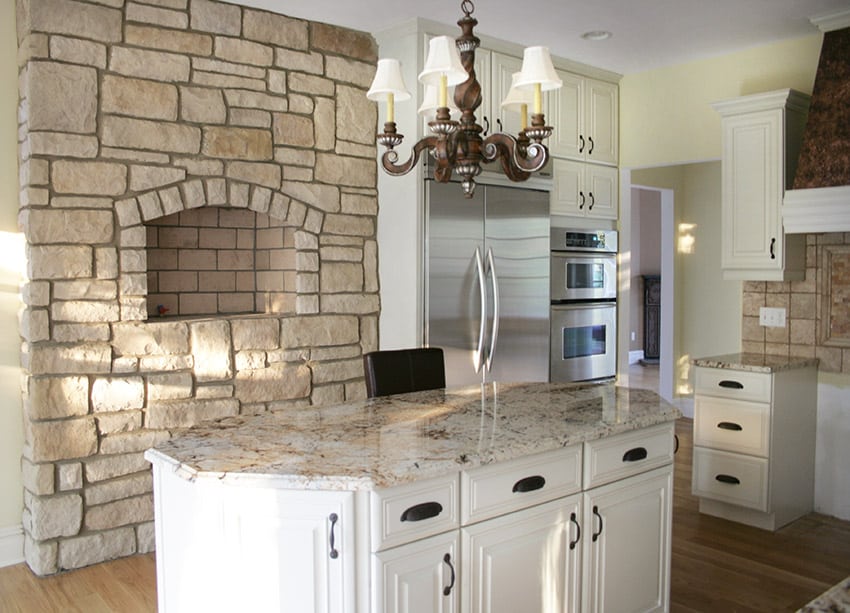 Compact kitchen with stone wall light granite and white cabinets