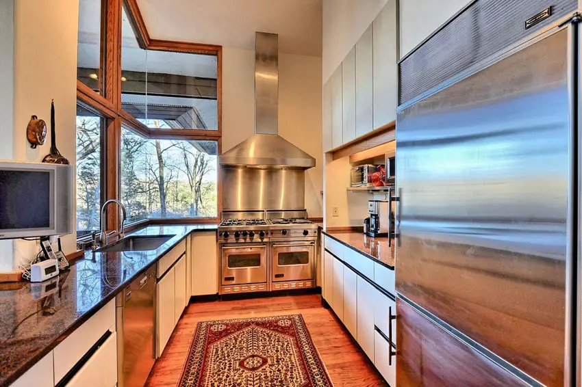 Contemporary galley kitchen with stove at end of room