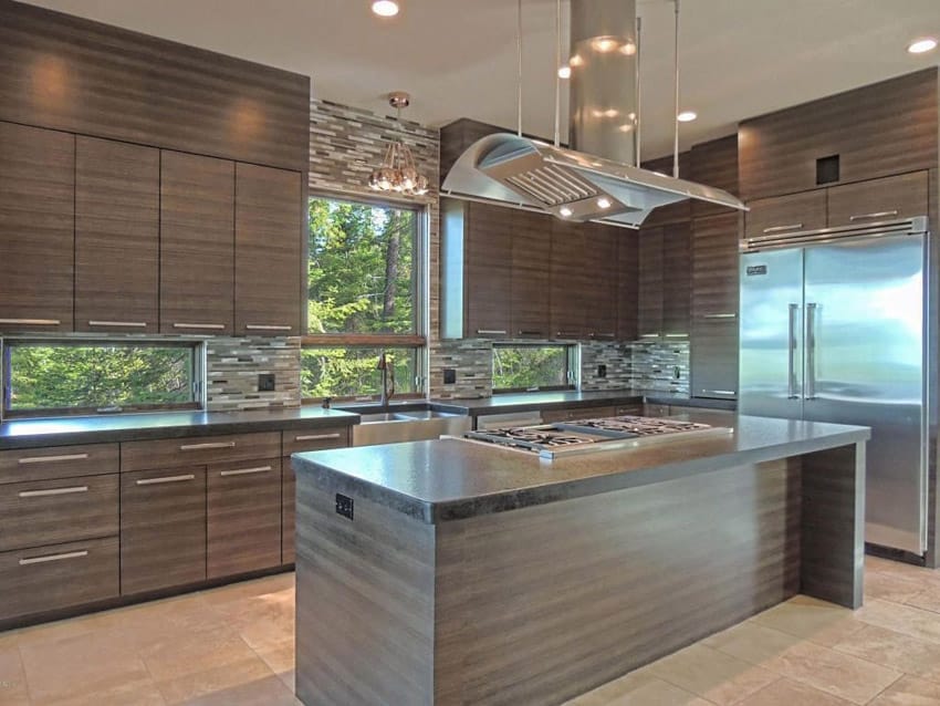 kitchen with dark veneer cabinetry glass mosaic tile backsplash and rectangular island