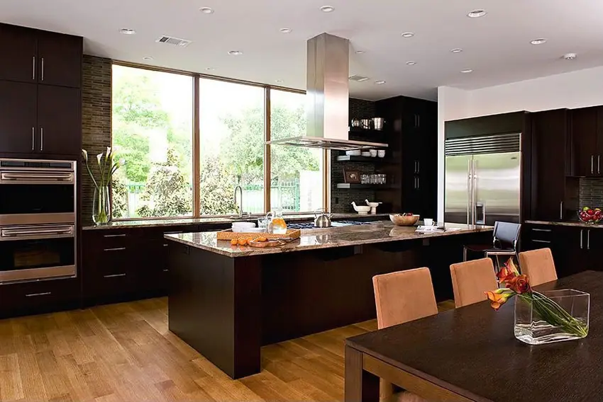 Kitchen with large windows, dark wood wenge cabinets and engineered bamboo floors