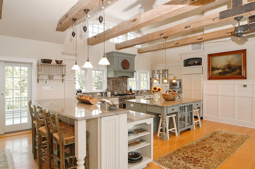 Country kitchen with bianco carrara marble counters and exposed beam ceiling