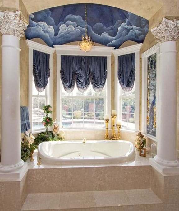 Elegant bathroom with pillars and ceiling mural with gold chandelier