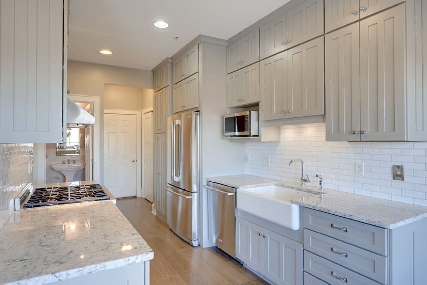 Galley kitchen with bathroom and subway tile