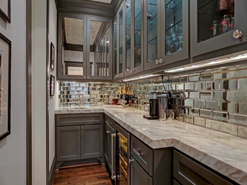 galley kitchen with shiny metal backsplash