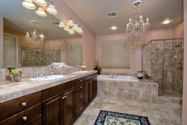 Great looking bathroom with decorative chandelier