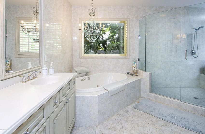 Intricate chandelier suspended over tub