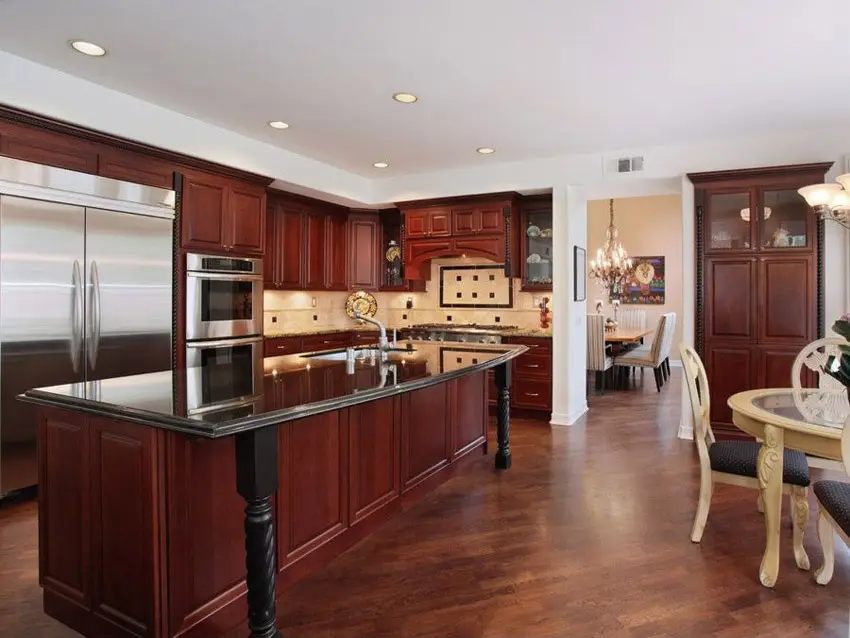 Kitchen with long island with rope legs and mahogany finish cabinets