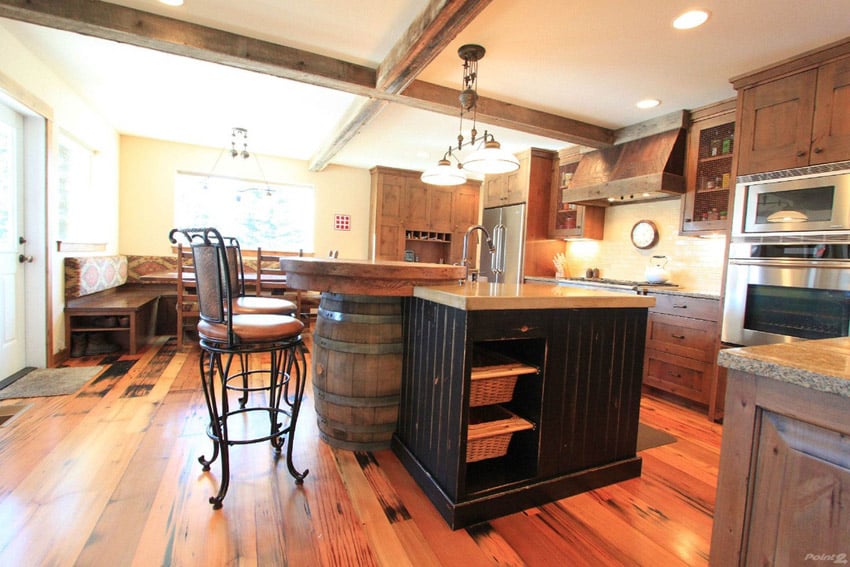 Rustic style kitchen with wine barrel island, exposed beams and wood flooring
