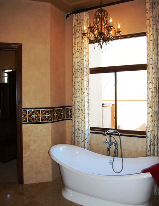 Lovely bathroom with curved bathtub and chandelier