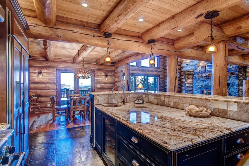 Kitchen with exposed beams, island with black finish and wooden walls