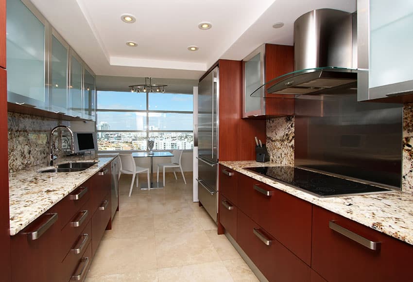 Modern galley kitchen with light granite counter in apartment