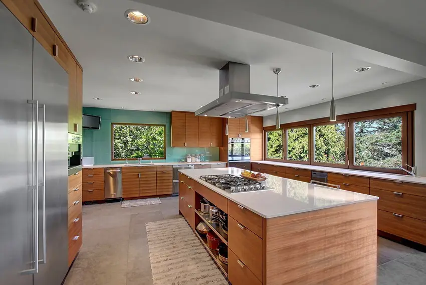Kitchen with cabinets made of wood laminates and gray concrete floors