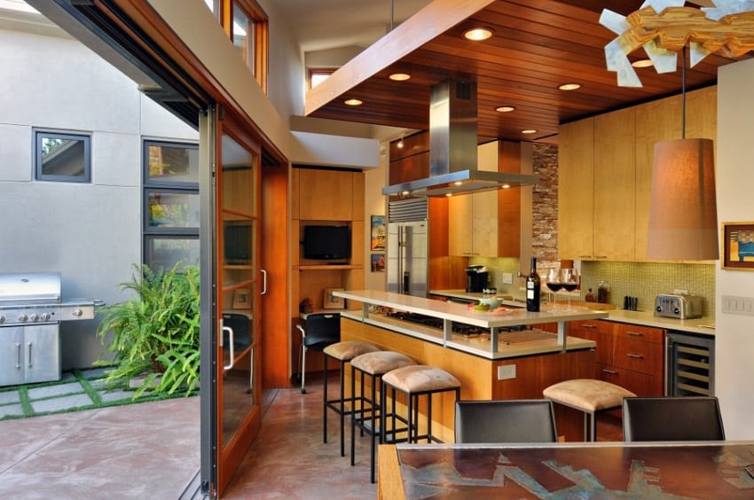 Modern kitchen with breakfast bar island and sliding door to back patio