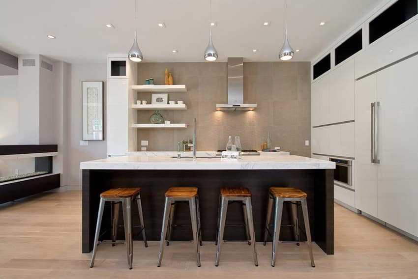 Open kitchen with concrete finish tiles, mahogany laminate style island and carrara marble