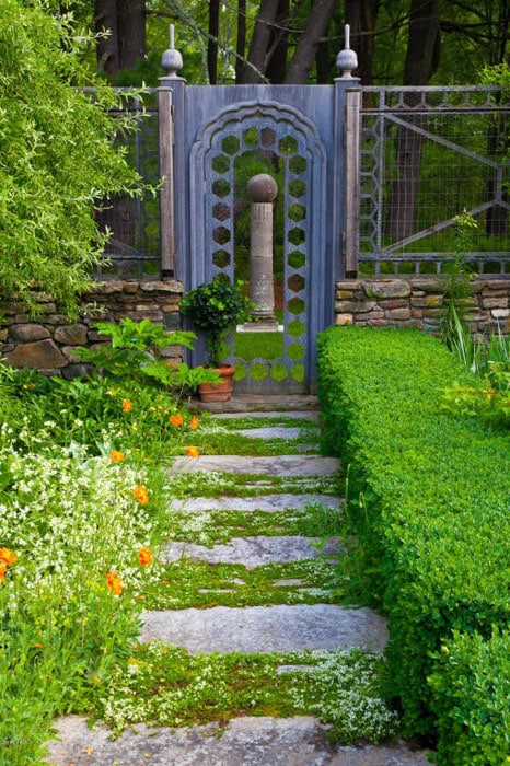 Rough stone path through garden to gate