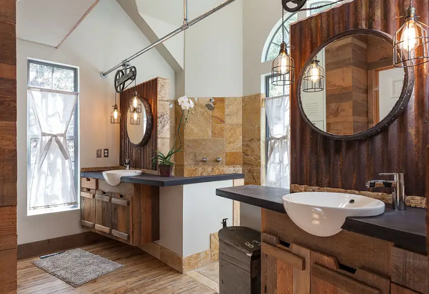 Rustic dual sink bathroom with wire cage pendant lights