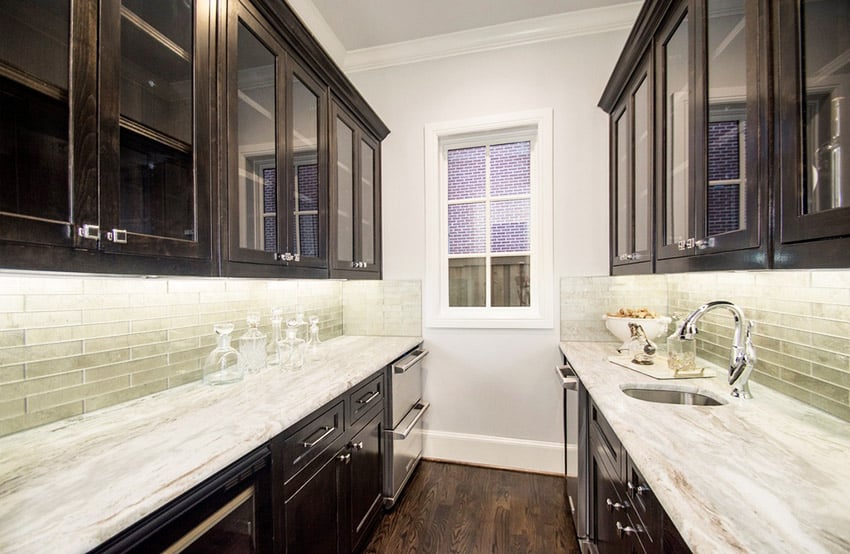 Small galley kitchen with sugar beige marble counters