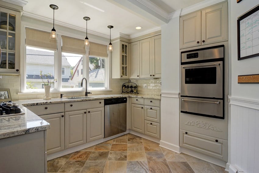 Small kitchen with calacatta vagli marble countertops and peninsula