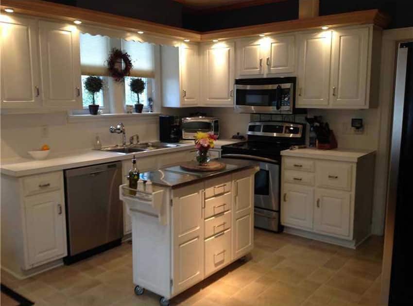 Small sland trolley with wheeled base and antique white painted cabinets